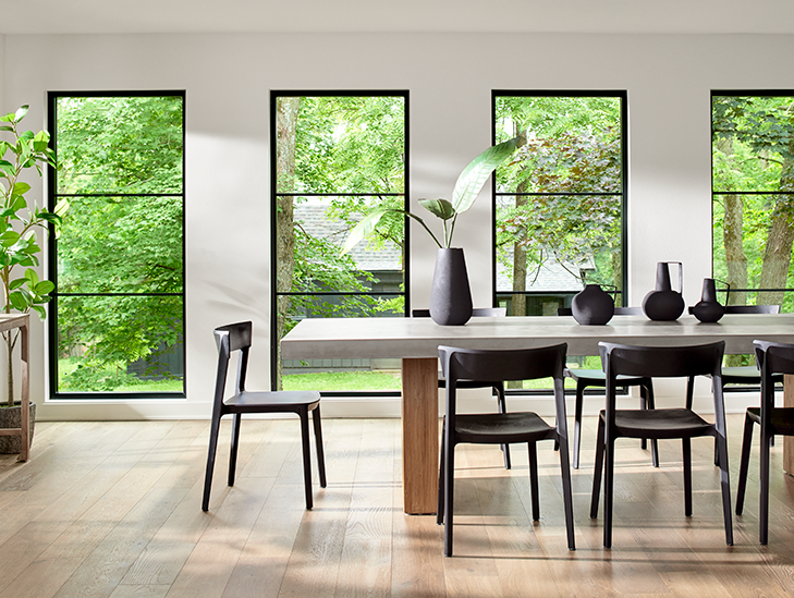 wood dining room set in a living room with wood windows
