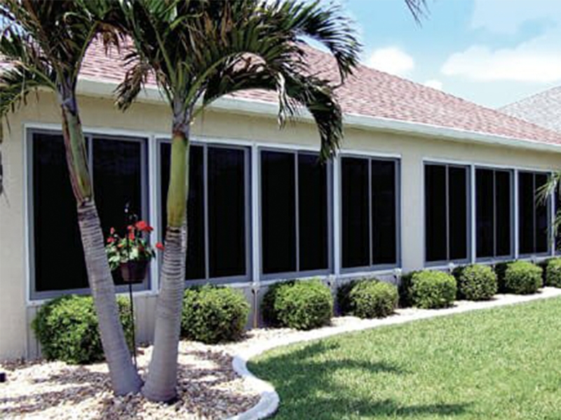 vertical sliding windows on a rustic coastal sunroom