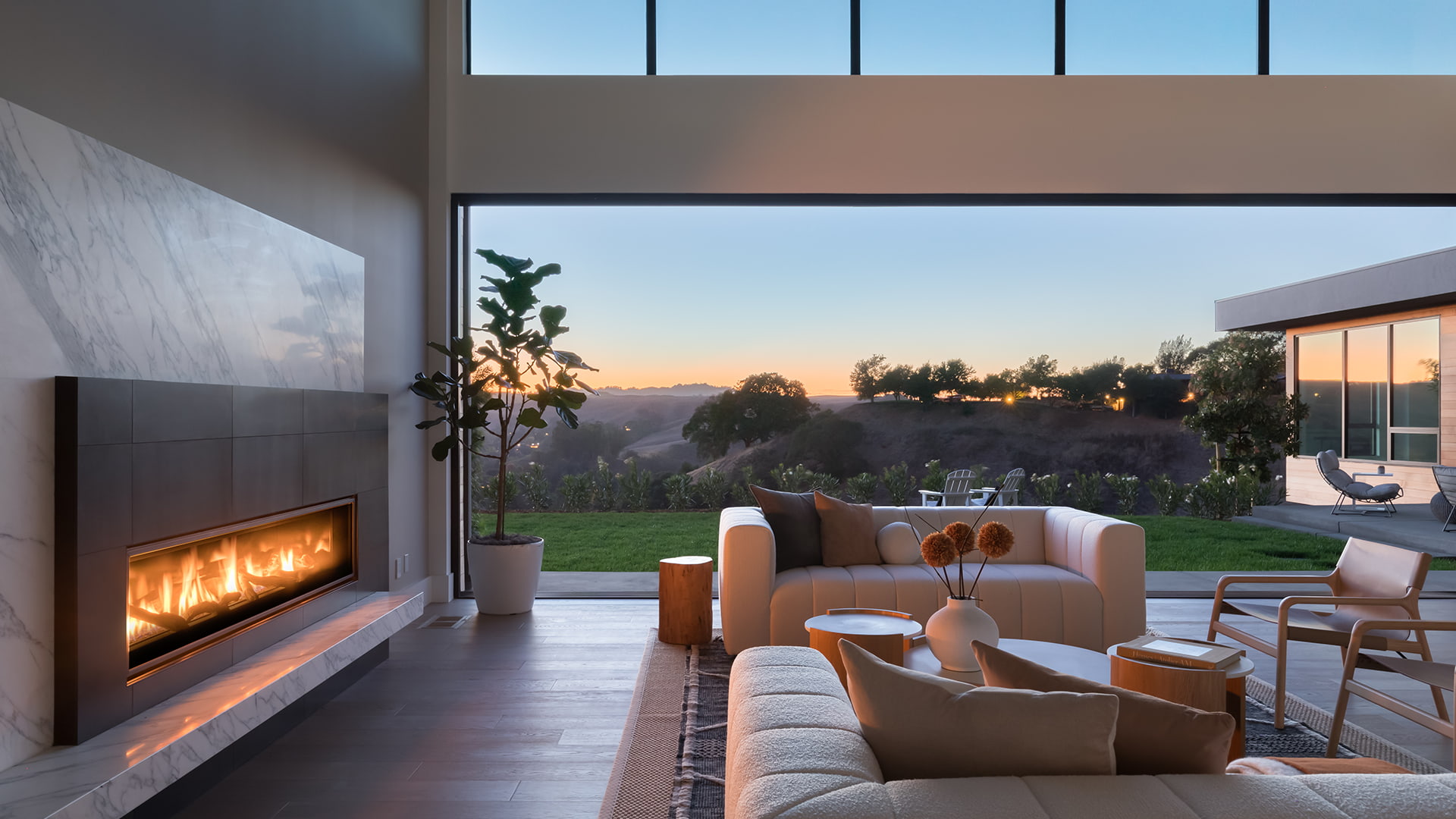 Lucas Ranch home interior at dusk with pocket doors open