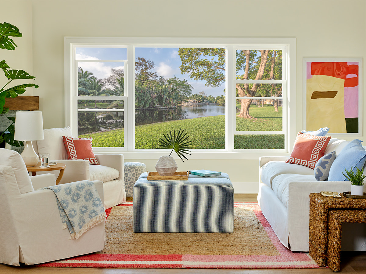  a traditional living room with white sofas in front of white vinyl double-hung windows