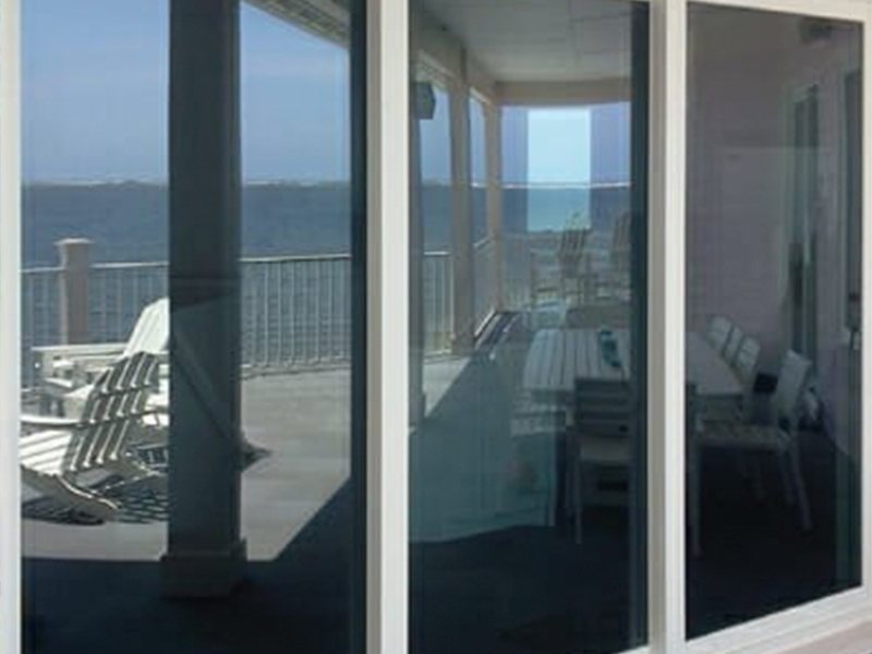 a glass sliding door on a coastal sunroom
