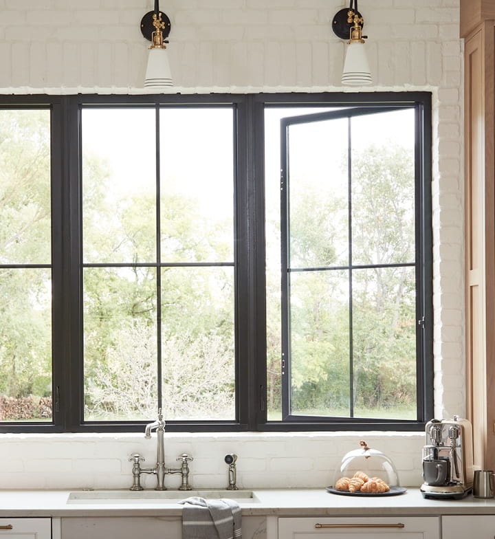 three fiberglass casement windows with the right window slightly opened.