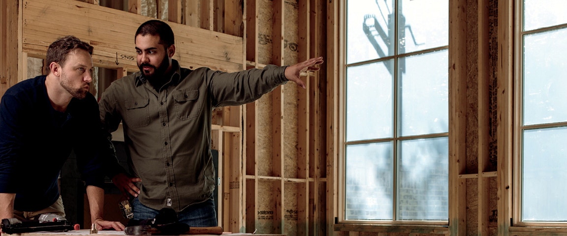 two contractors discussing the window installation