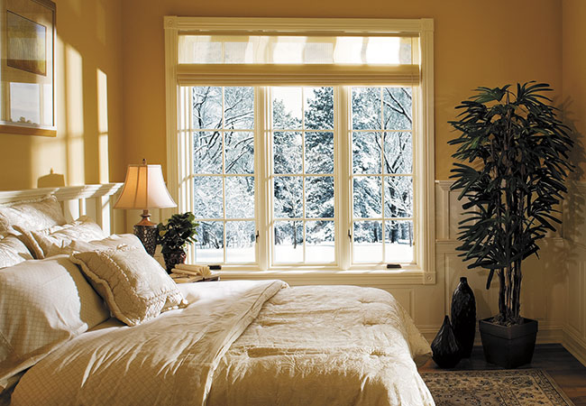 a three-wide window unit in a yellow bedroom
