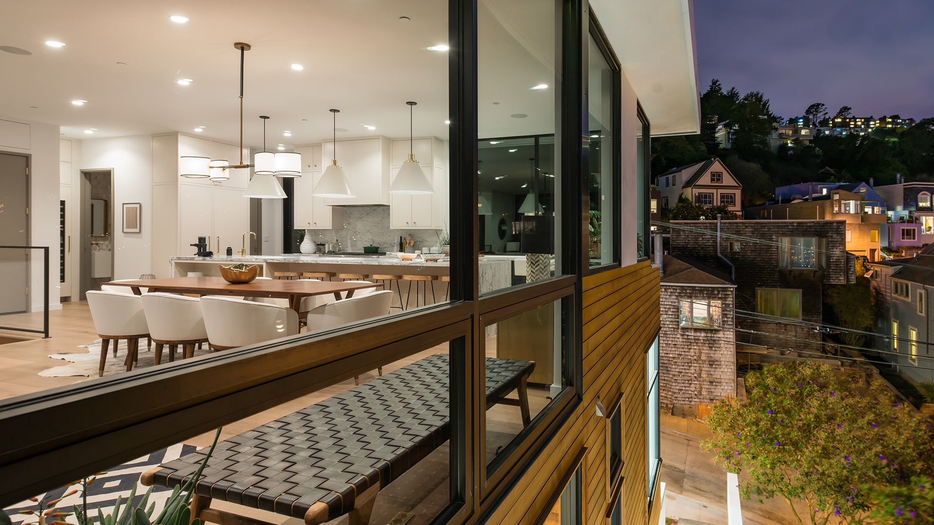viewed from the exterior, an open concept home is well lit from the inside