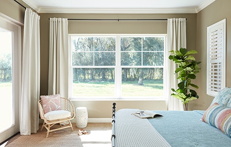 two single-hung windows in a bedroom