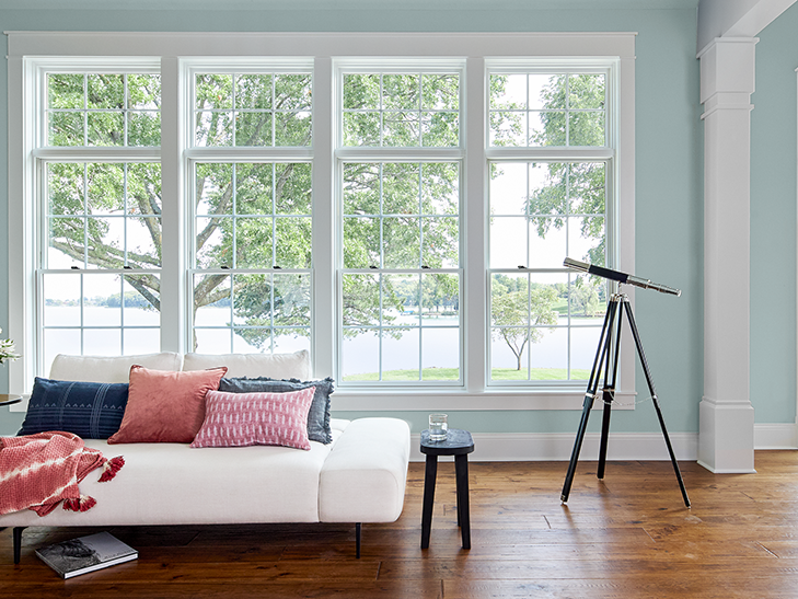 four double-hung windows showing a lake view