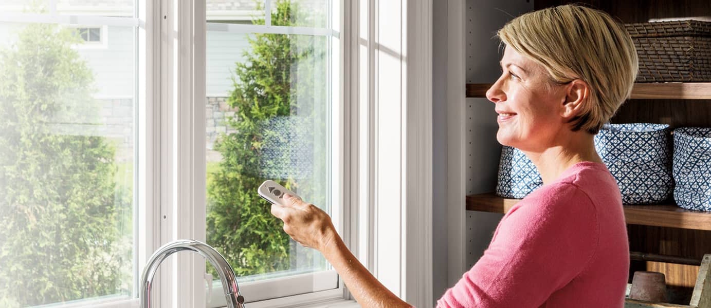 A woman using an Insynctive remote on her windows