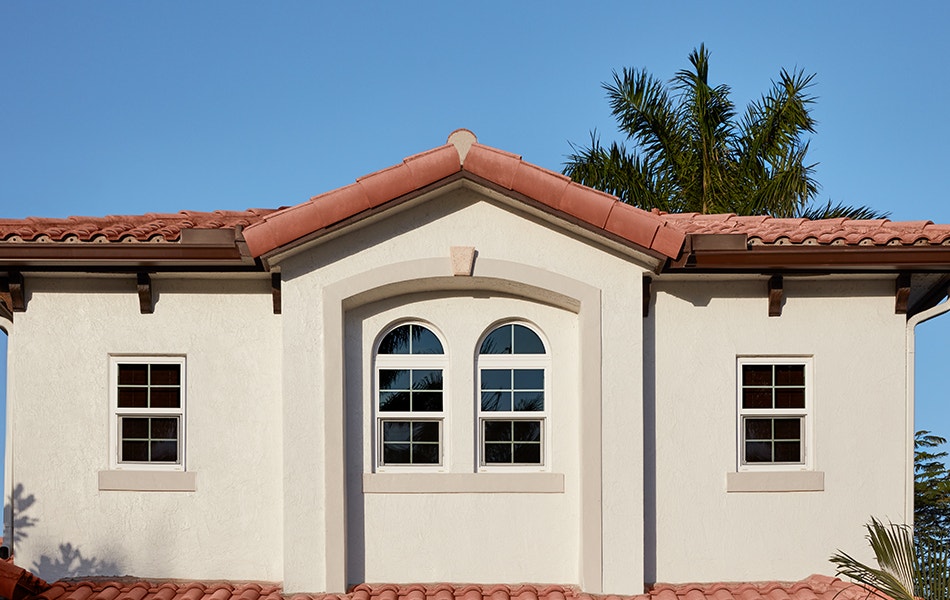 a Spanish-style home exterior with four double-hung windows