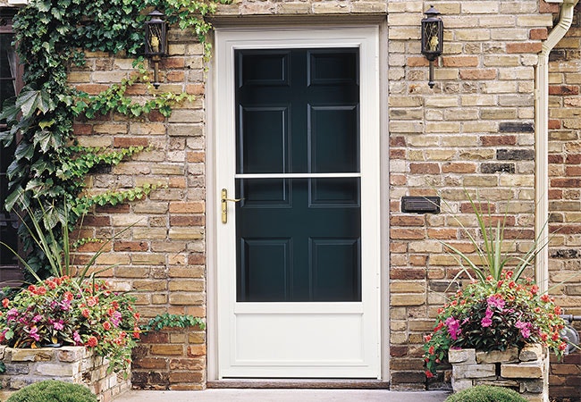 a white storm door in front of a dark blue solid entry door