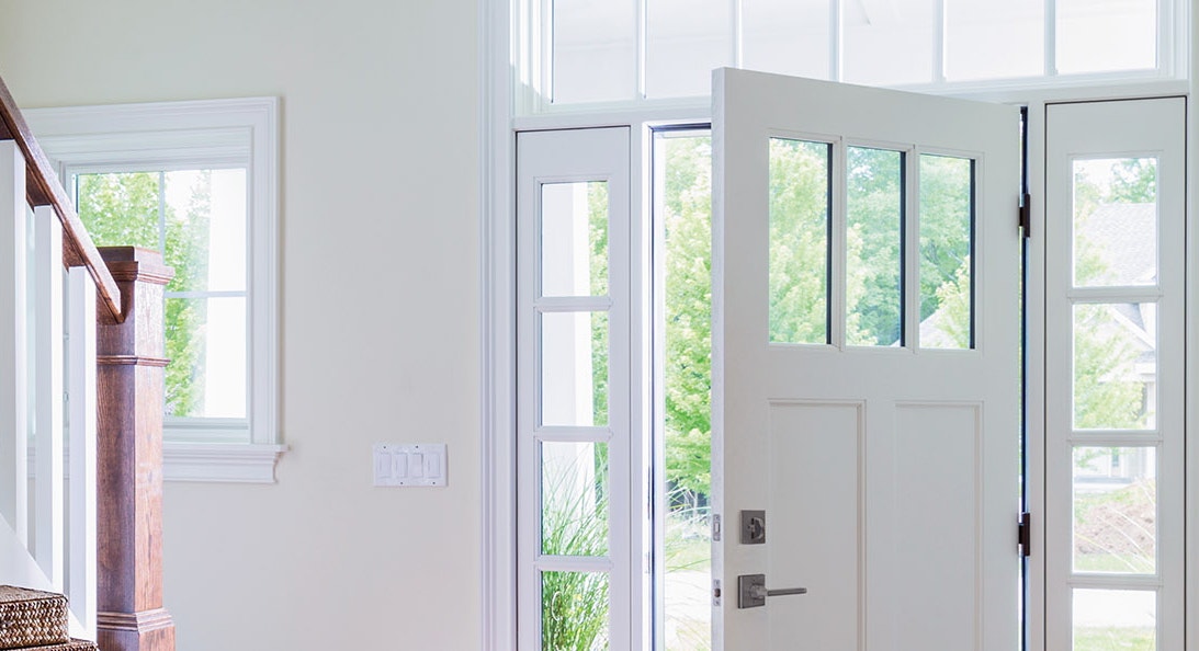 a white Pella front entry door with full light sidelights on each side, as viewed from the interior