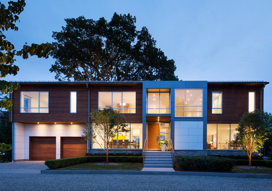 A mid-century modern home exterior at dusk