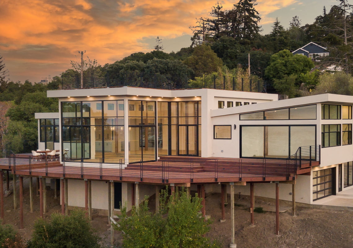 A mid-century modern home exterior at dusk