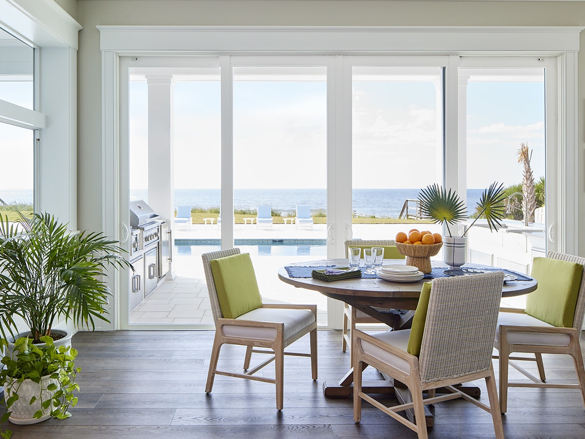 White sliding patio doors between a kitchen and an outdoor deck