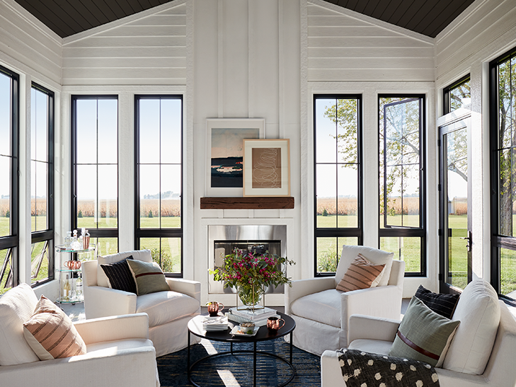 A threeseason room with tall casement windows on each wall A threeseason room with tall casement windows on each wall