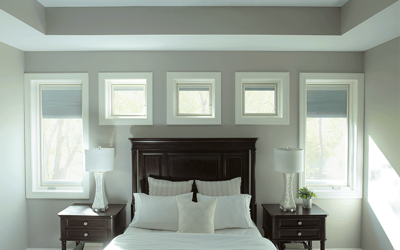 five windows surround a traditional bed frame