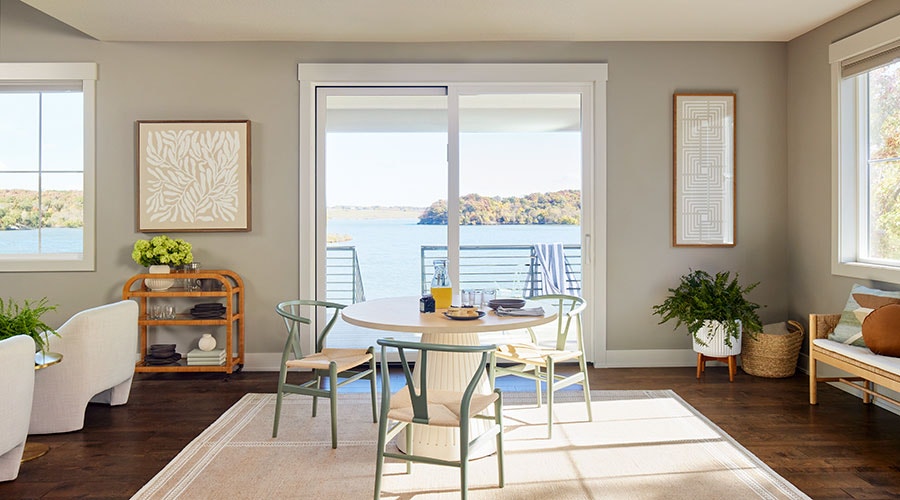 white wood sliding patio door that opens to a lake view