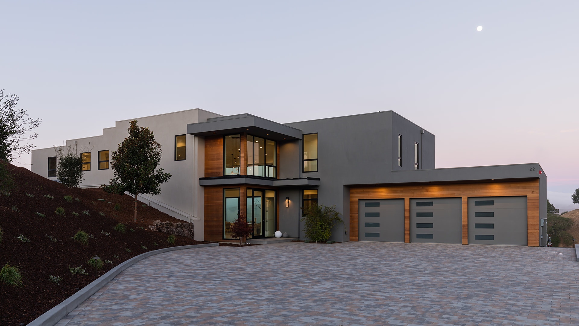 A California hilltop home exterior with a stone driveway