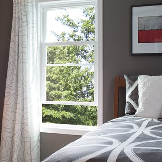 an open window beside a bed