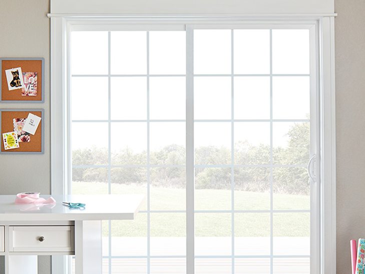 a craft room with a white vinyl sliding patio door 