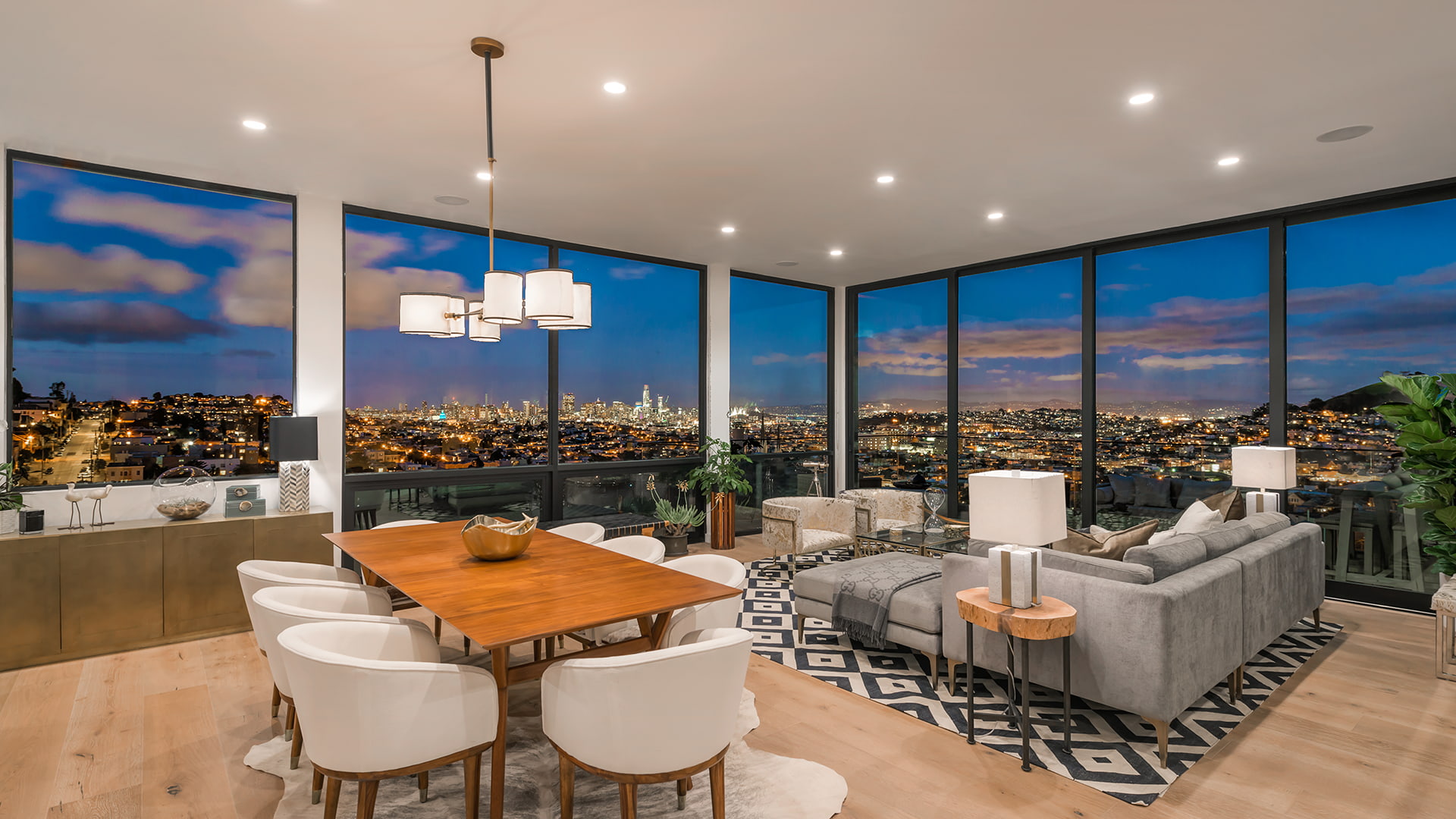 A Penthouse interior at night with the lit city skyline outside