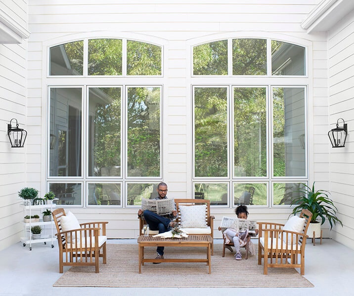 A father and daughter sitting in front of two sets of 9-window configurations.