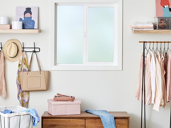 a sliding window behind a mudroom filled with household items