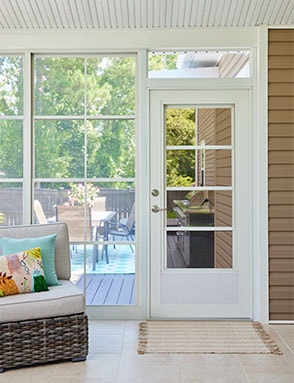 vertical sliding windows on a coastal and rustic sunroom