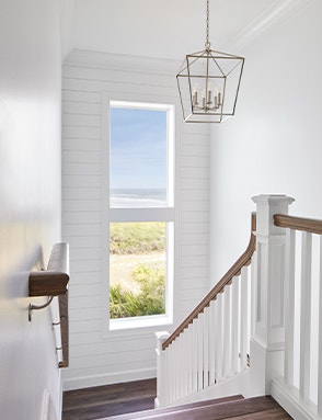 a white single-hung window on a staircase landing