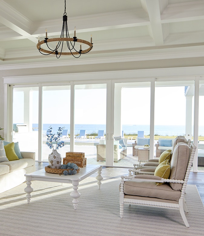 a white sliding patio door on a blue home exterior