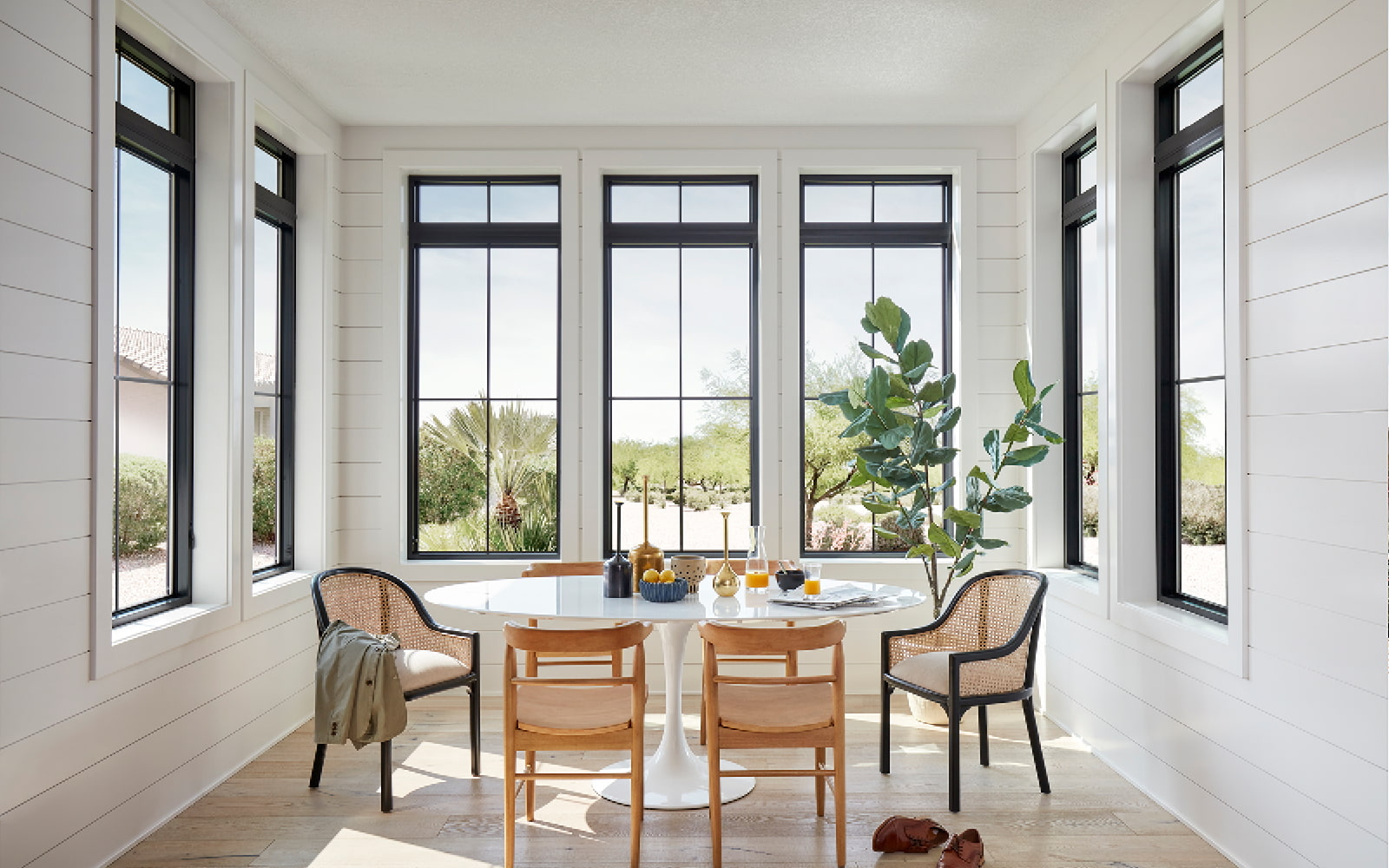 white dining room with black casement windows on each wall