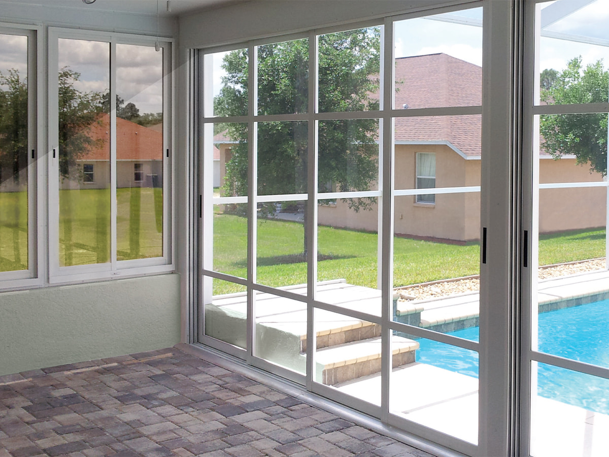 A sunroom next to a swimming pool with multi-vent sunroom windows