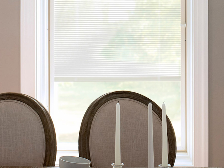 two formal dining room chairs in front of a single casement window with blinds-between-the-glass