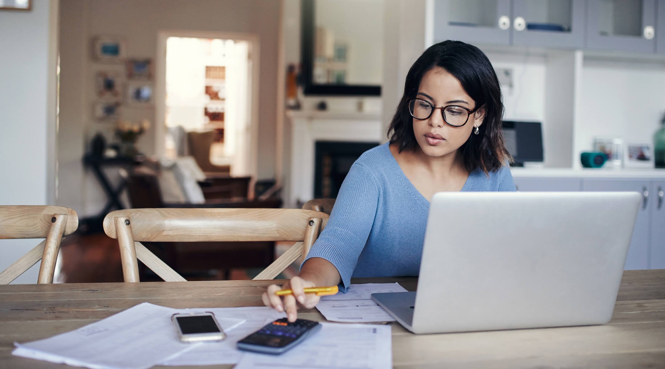 Woman working on financials on her laptop