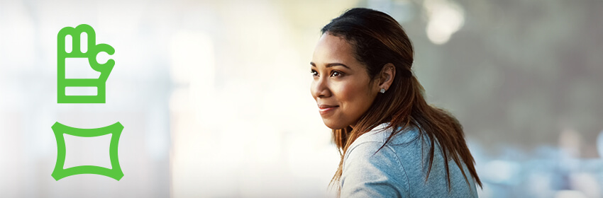 Woman smiling as she looks over her shoulder.