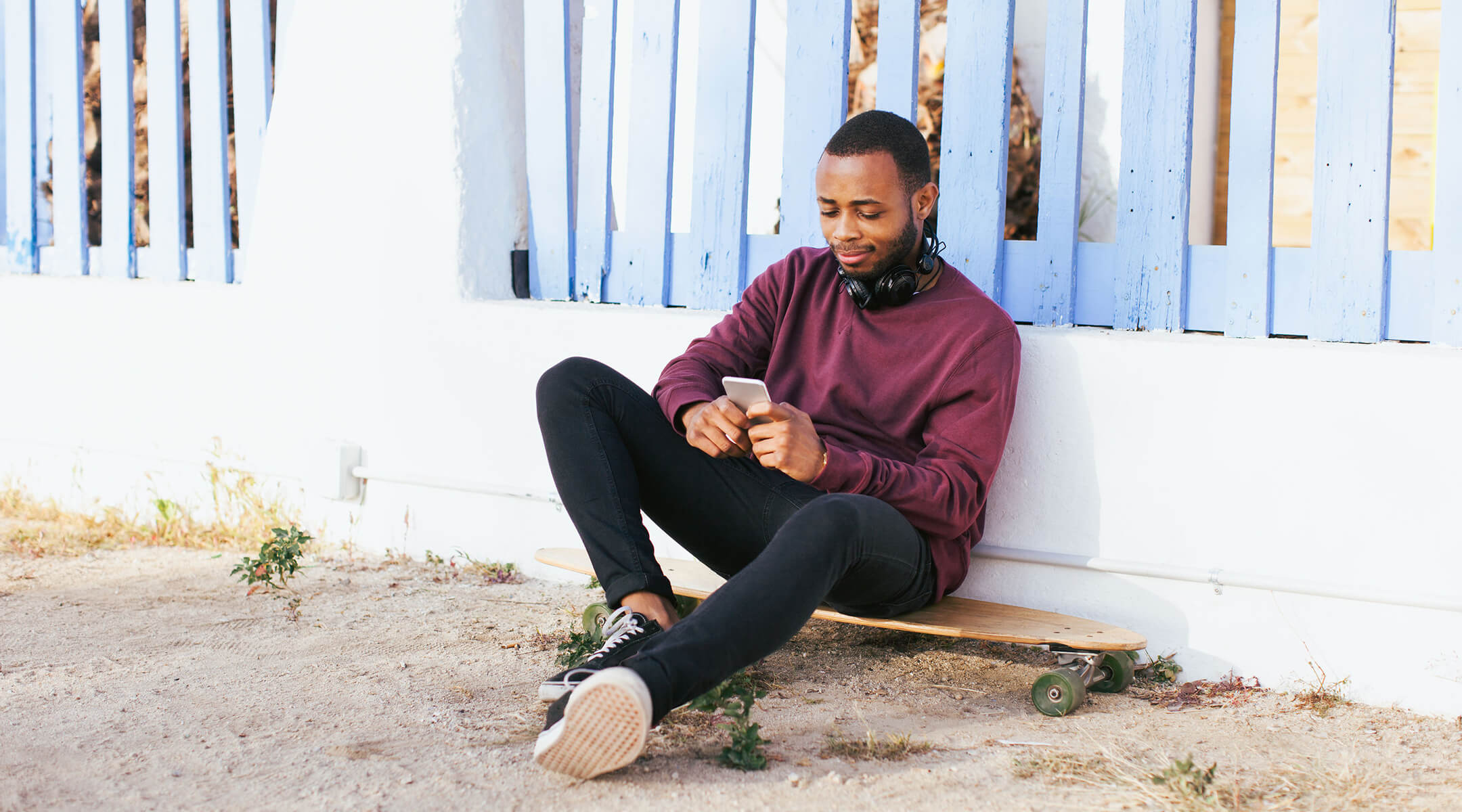 Man sitting while checking his phone