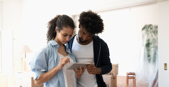 Man and woman using a tablet to research credit building tools and strategies for improving their credit score.
