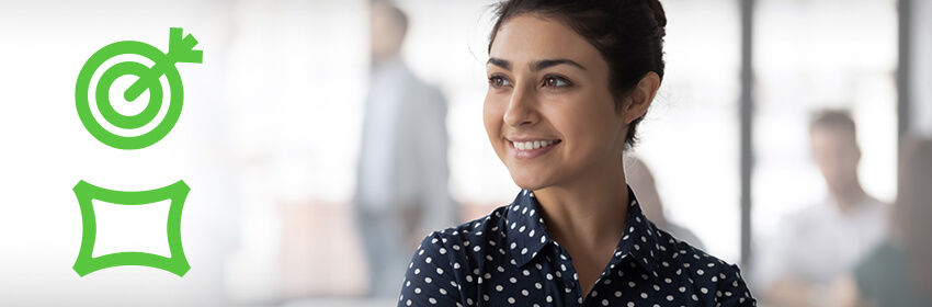 Woman in an office building smiling.