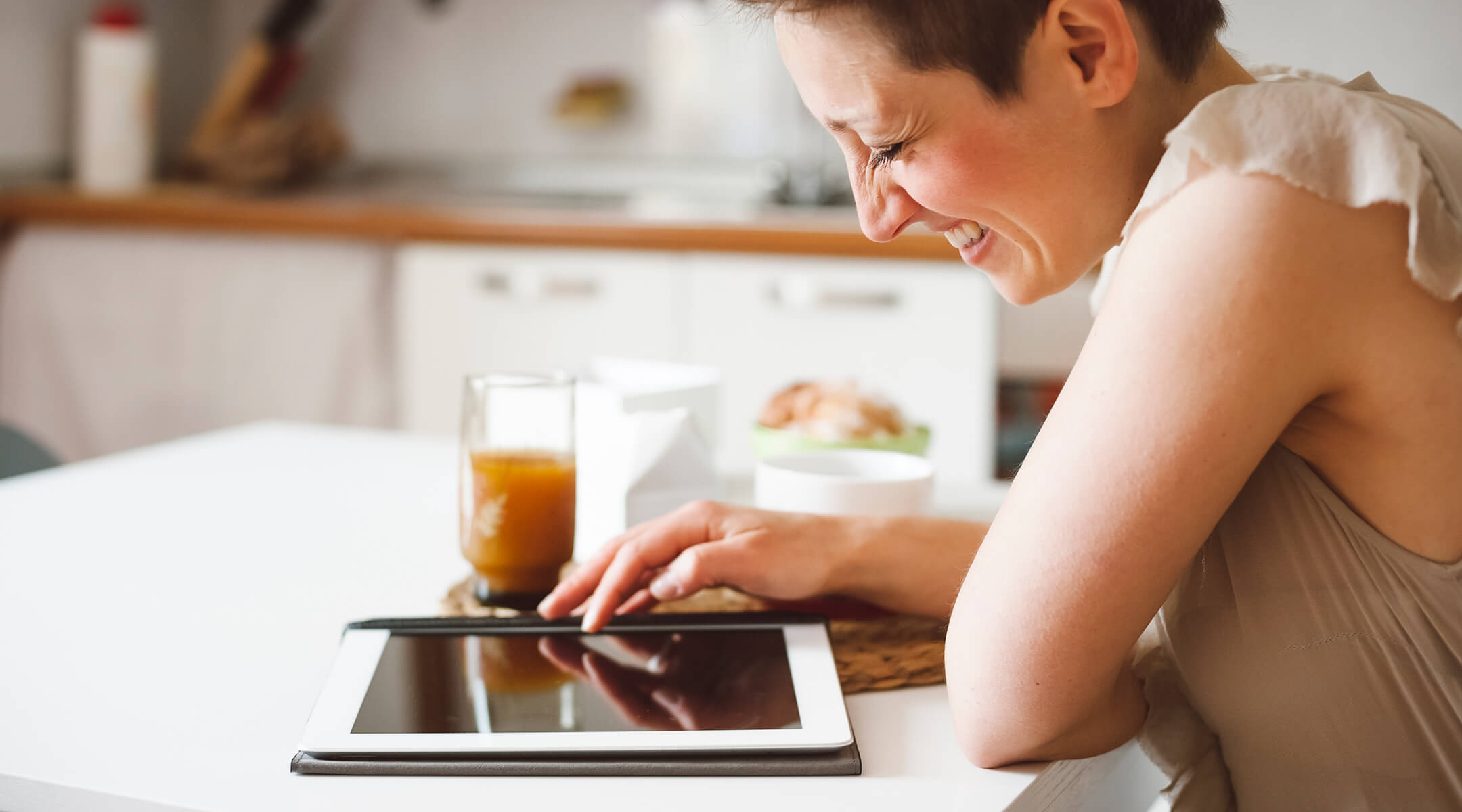 Woman on smart tablet in kitchen