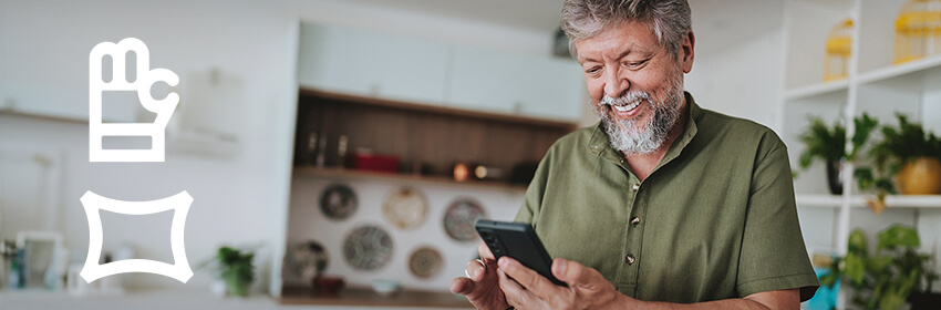 Older gentleman smiling as he uses his smartphone.