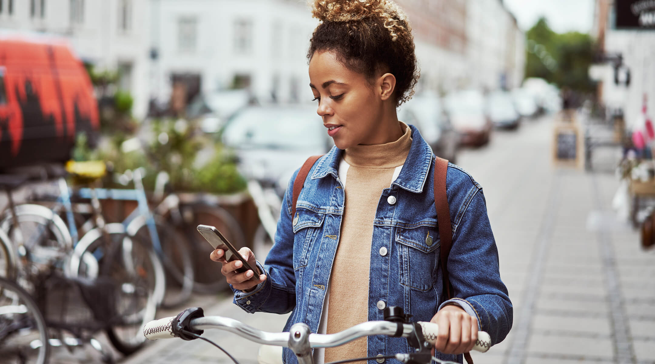 Woman walking through Raleigh, North Carolina checking her phone