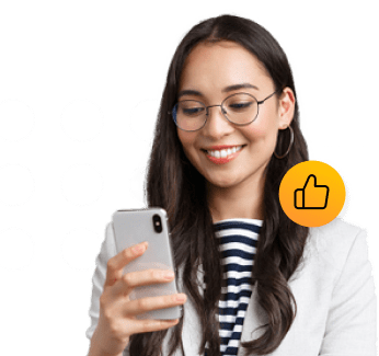 A young woman smiling while looking at a cellphone she is holding.