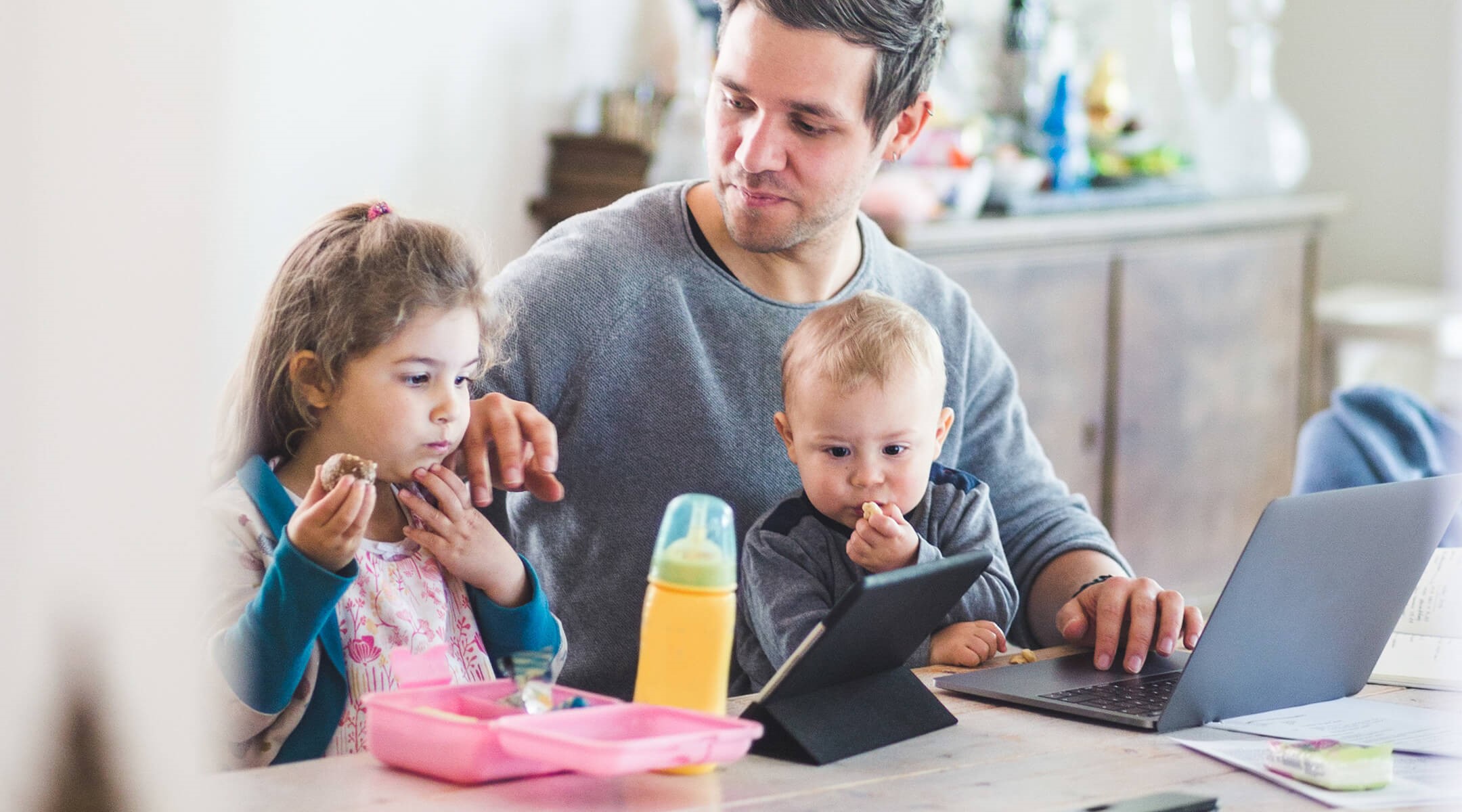 Father working on his financials and with his two children