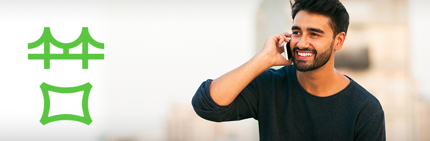 Man smiling as he talks on his cellphone.