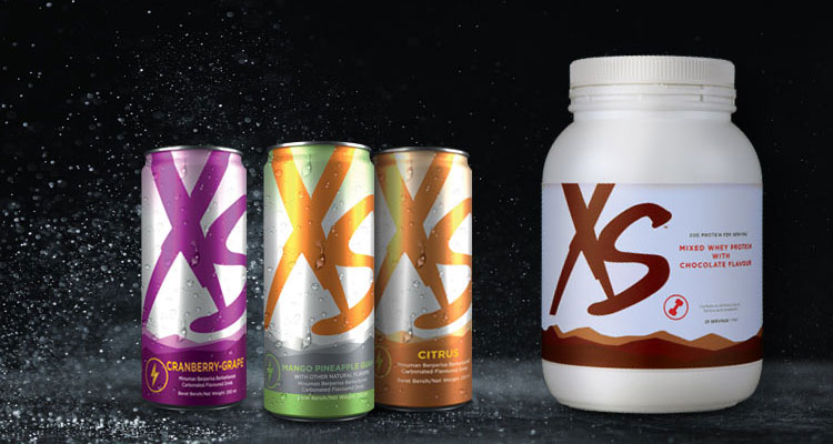 Line up shot of XS Energy Drinks and XS Mixed Whey Protein with Chocolate Flavour