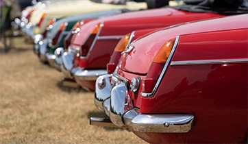 Close up of the back of a number of classic cars