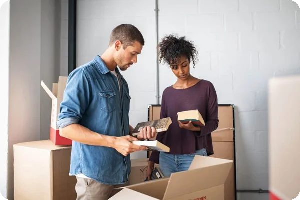 a couple looks over the books they're packing