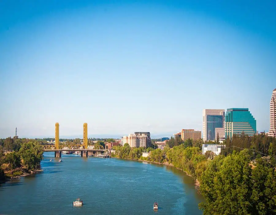 Downtown Sacramento skyline with the Tower Bridge over the river on a clear day.