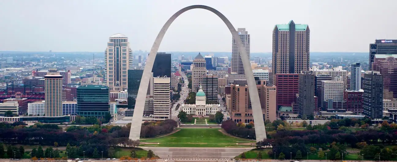 A view of Saint Louis, MO's skyline as seen through the space underneath the Gateway Arch