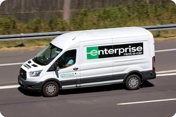 An Enterprise van drives down a road